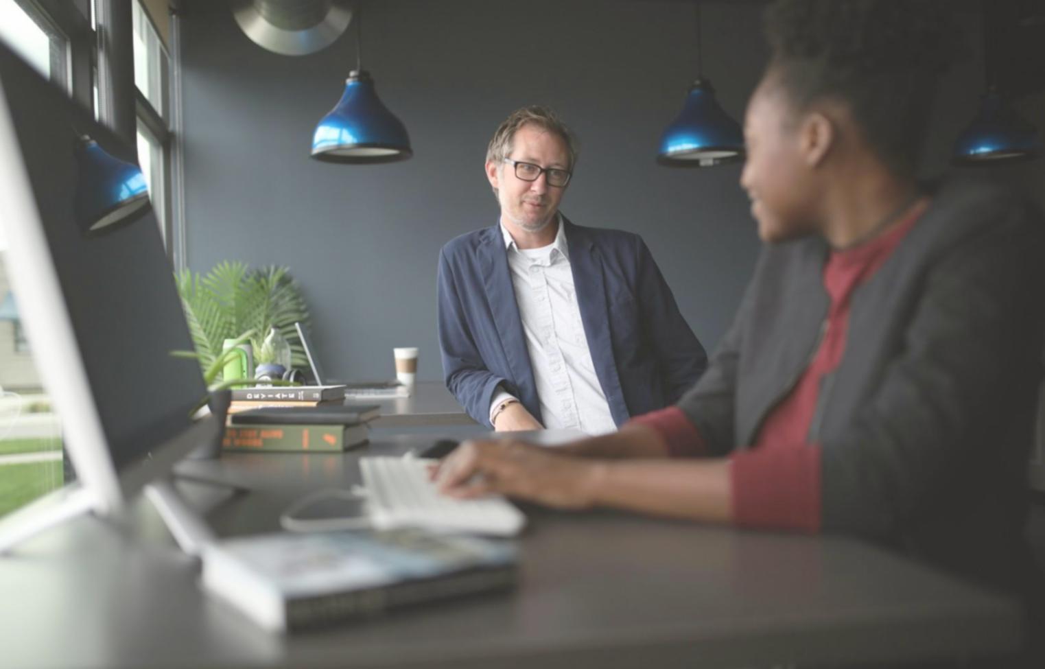Group of students collaborating on investment analysis and sharing insights